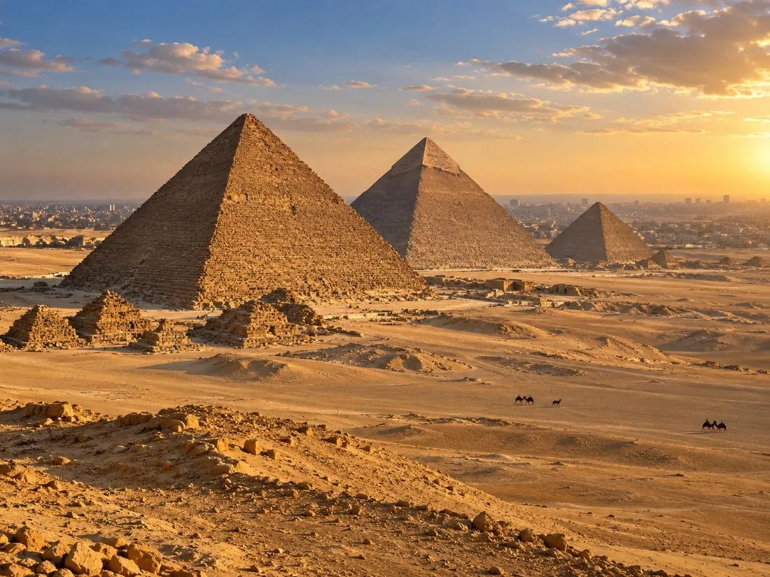 All the pyramids of Giza in a line across the desert, seen from the panorama viewpoint in golden light